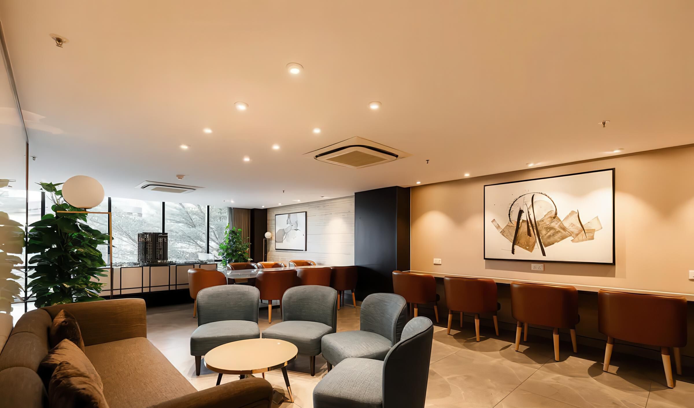 A modern lounge area with comfortable seating, a bar, and a large abstract painting on the wall.