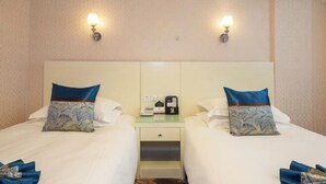A hotel room with two beds, a nightstand with a phone and a coffee maker, and wall-mounted lights. - Hengdian World Studios Hengpiao Grand Hotel (Dongyang)