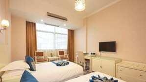 A hotel room with two beds, a desk, a chair, a television, and a window. - Hengdian World Studios Hengpiao Grand Hotel (Dongyang)
