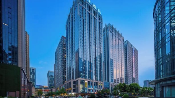 A high-rise building with a modern glass facade, surrounded by other tall buildings. - JI Hotel (Chengdu Global Center) (Chengdu)
