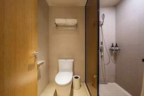 A small, modern bathroom with a toilet, a shower, and a towel rack. - JI Hotel (Chengdu Global Center) (Chengdu)