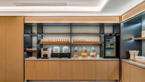 A modern kitchen with built-in appliances, wooden cabinets, and a glass-fronted beverage station. - JI Hotel (Chengdu Global Center) (Chengdu)