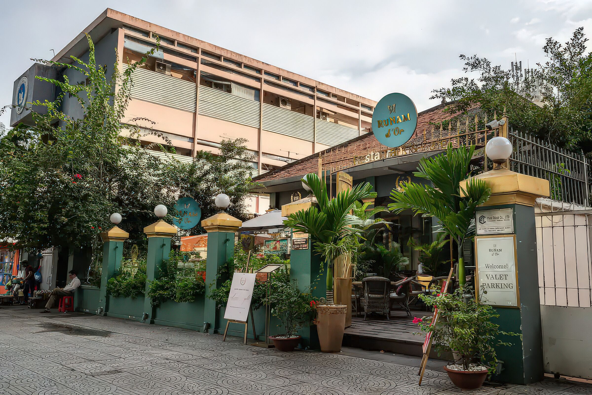 A building with a sign reading "VALET PARKING" and a signboard with a logo.