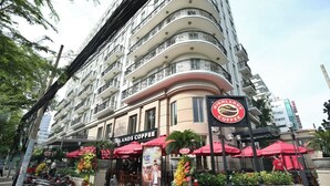 A multi-story building with a coffee shop on the ground floor.