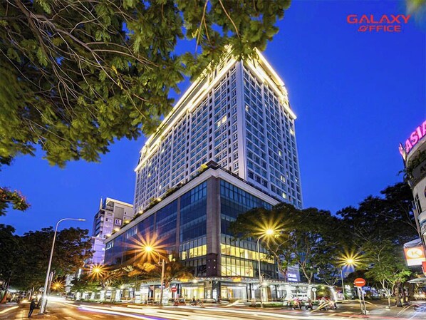 A high-rise hotel with multiple floors, large windows, and a prominent "Galaxy Office" sign. - Salute de Léman - Luxury Apartment District 3 (Ho Chi Minh City)