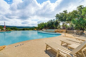 A swimming pool with lounge chairs and a lifeguard stand. - Lake Travis Views! Hollows Cabin, Pools, Sleeps 10 (Jonestown)