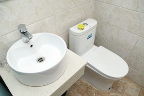A bathroom with a white sink, toilet, and bathtub. - Tianjin Liansong Hotel (Tianjin)