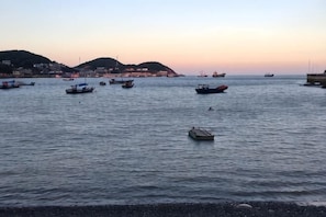 A calm harbor with boats and a dock.