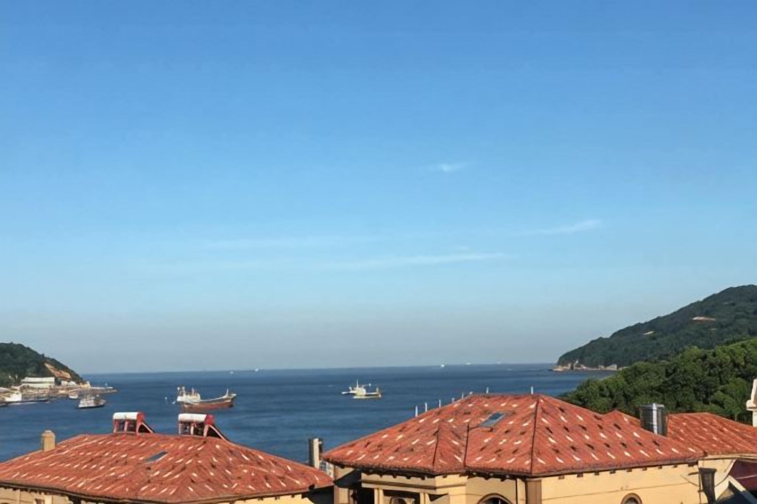 A coastal view with buildings and boats.
