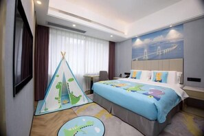 A hotel room with a bed, a desk, a chair, a window with curtains, and a wall mural. - Tianhe Hotel (Guangzhou)