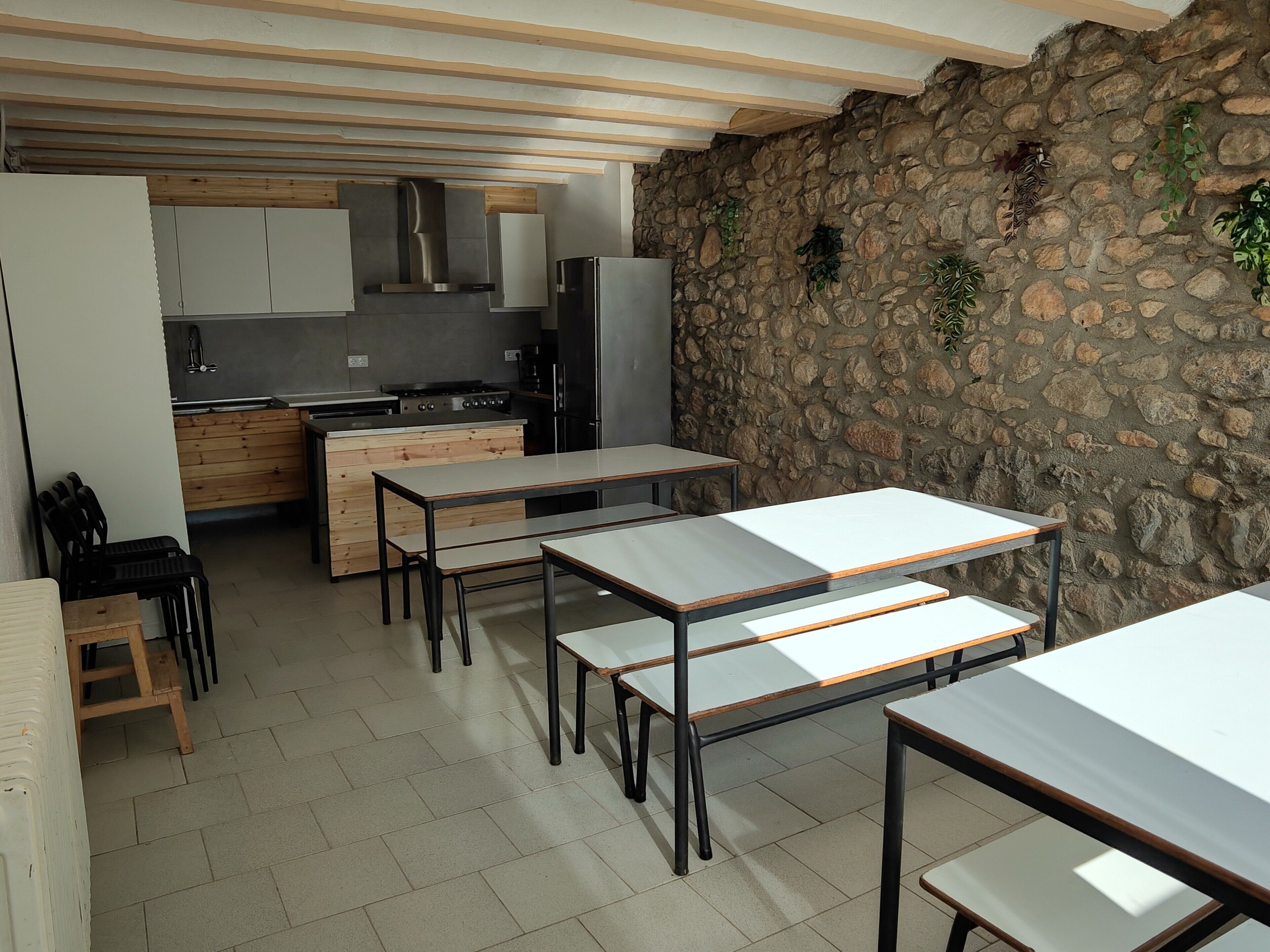 A modern kitchen with a stone wall, wooden cabinets, and a built-in stove.