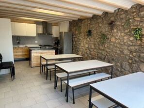 A modern kitchen with a stone wall, wooden cabinets, and a central island.