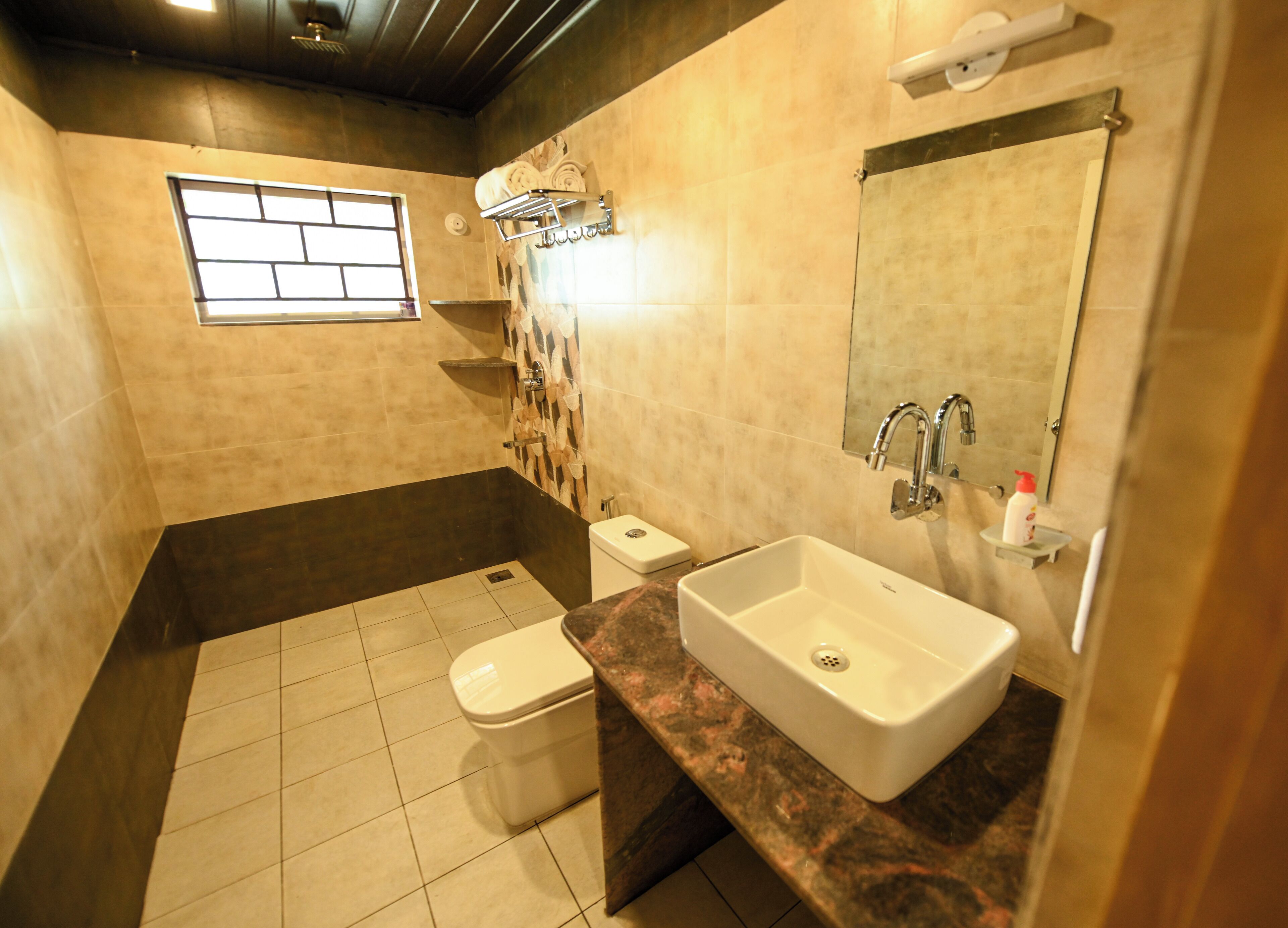 A bathroom with a bathtub, a toilet, a sink, and a window.