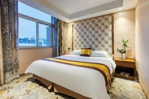 A hotel room with a large bed, a tufted headboard, a nightstand, and a window with a view. - Geyue Zhenpin Hotel (Hangzhou)