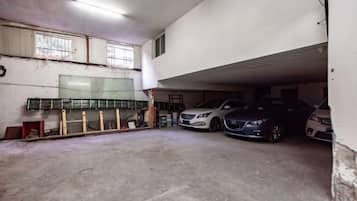 A multi-level parking garage with two cars parked on the upper level.