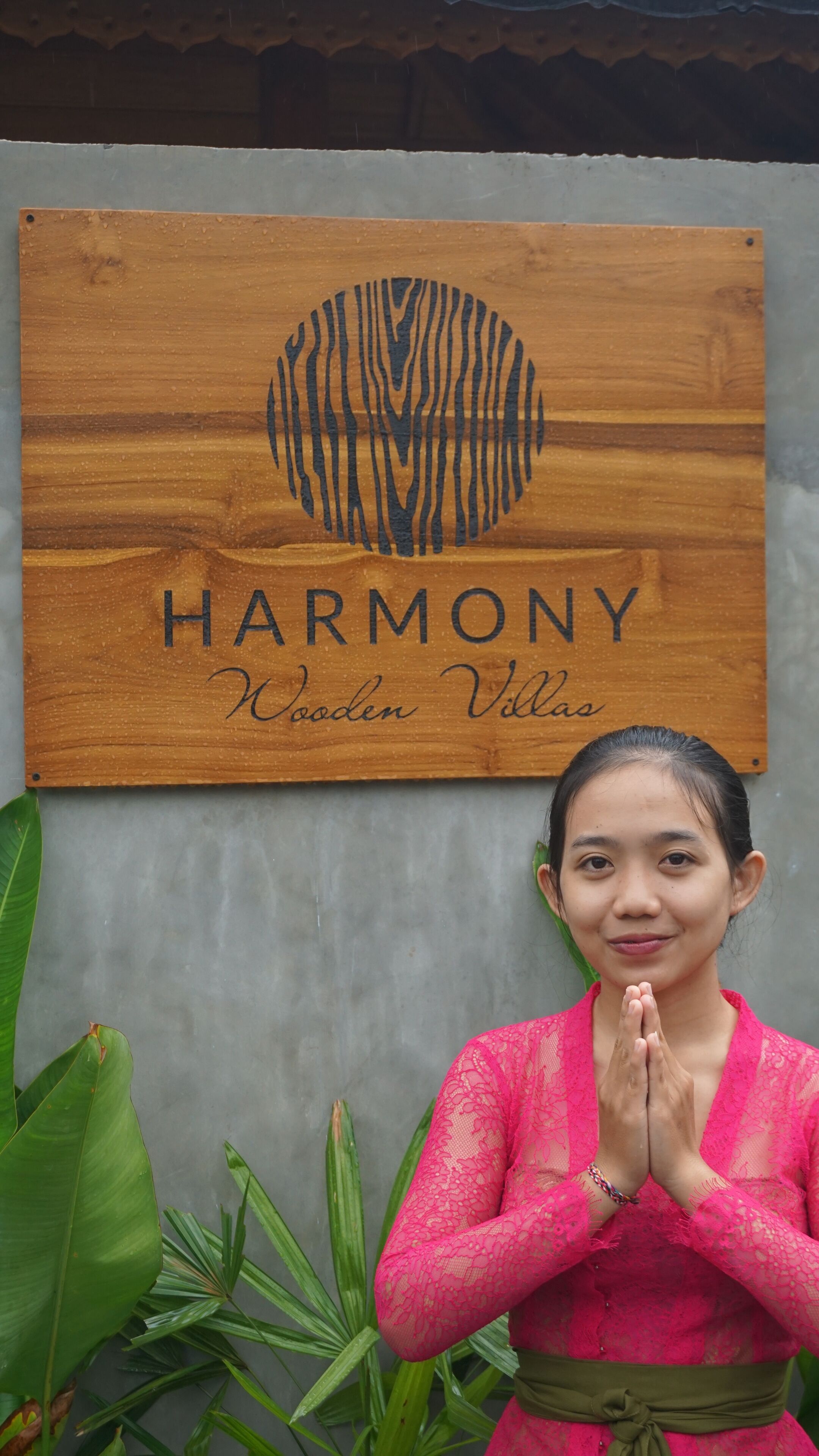 A wooden sign with the word "HARMONY" and "Wooden Villa" written on it.