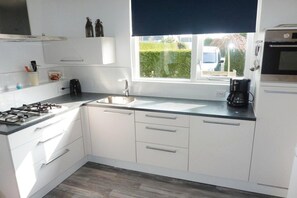 Fridge, stovetop, dishwasher, coffee/tea maker