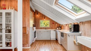 A modern kitchen with wooden floors, white cabinetry, and a skylight. - "Palle" - 400m from the sea by Interhome (Ebeltoft)