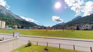 A residential area with a sign indicating 'RESIDENCE AM SEE' and a view of a road leading to a mountainous landscape. - Well-kept holiday apartament house in a prime location in St. (St. Moritz)