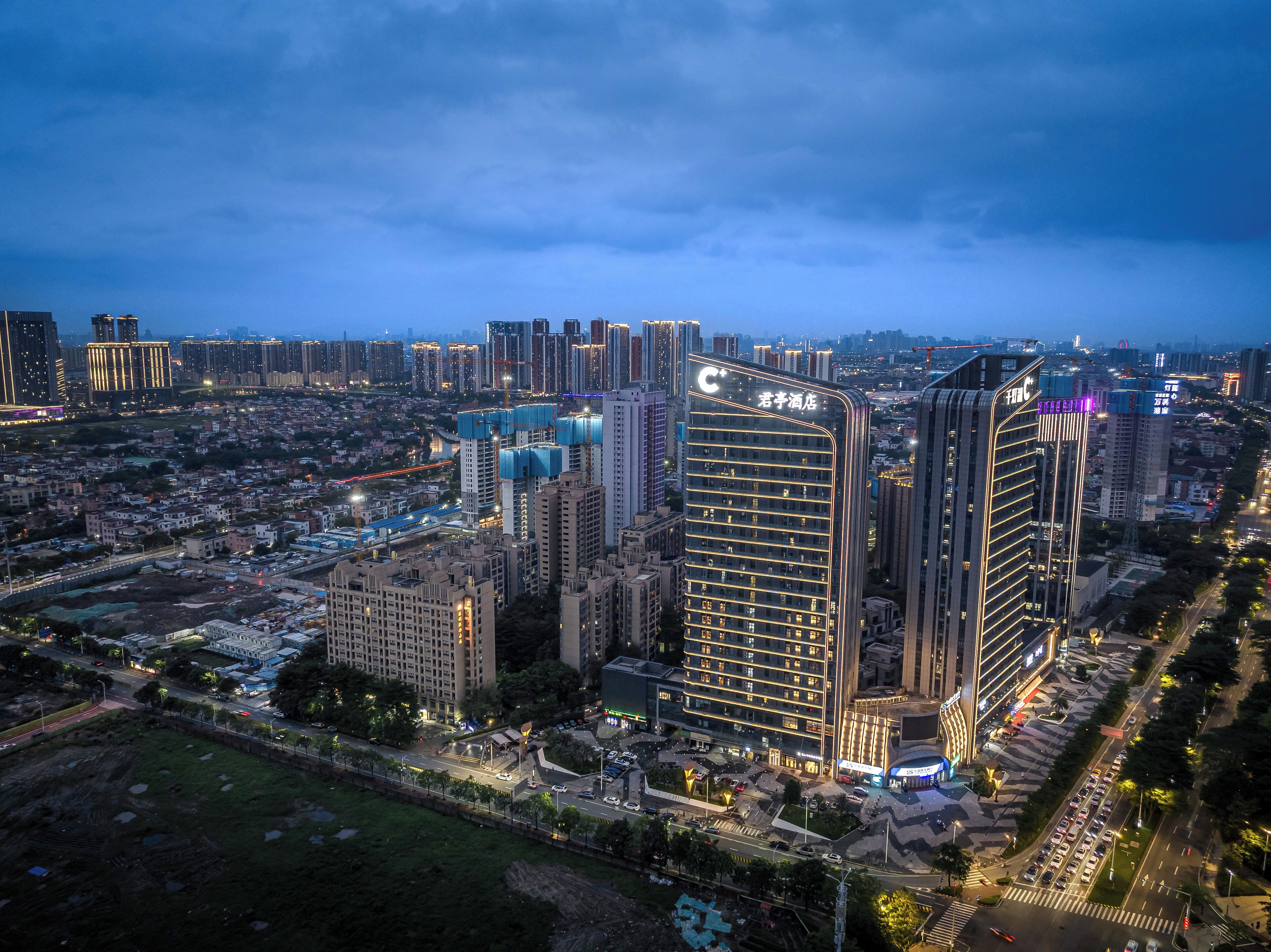 A high-rise hotel with multiple floors, a prominent 'C' logo, and a modern architectural design.