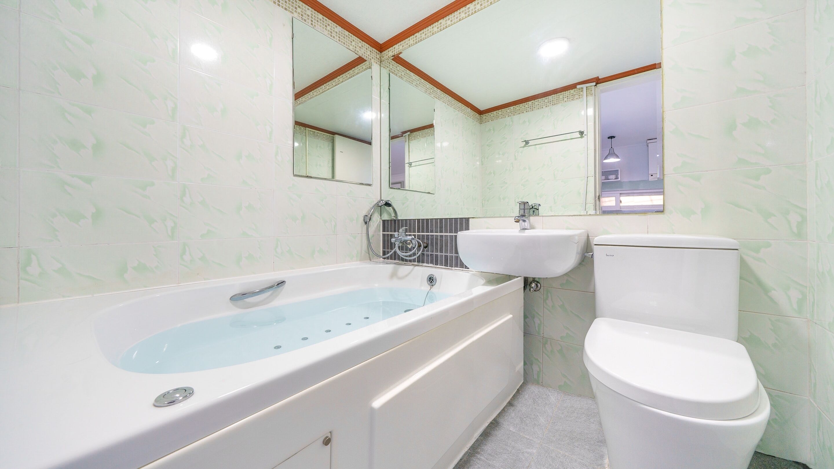 A bathroom with a bathtub, a sink, and a toilet.