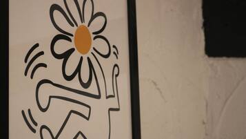 A framed artwork with a stylized flower and abstract design.