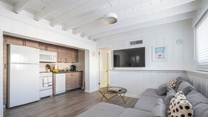 A modern kitchen with white appliances, a dining area with a glass table, and a living room with a grey sofa. - BRIGHT Fort Lauderdale Tropical Retreat (Fort Lauderdale)