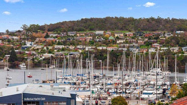 A marina with numerous sailboats docked, a building labeled "Bellerive Yacht Club," and a hillside of residential buildings in the background. - Residential Retreat, Groups & Families-Sleeps 15 (Warrane)