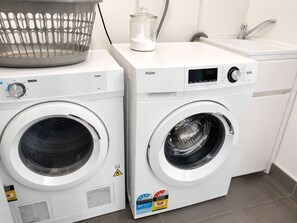 A front-loading washer and dryer side by side in a laundry room.