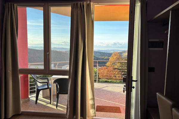 Comfort Quadruple Room, Hill View | Living area | TV