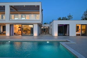 A modern two-story house with a swimming pool in the foreground. - Luxury Villa Sonia With Wellness Gym (Sveta Nedelja)