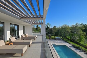 A modern outdoor pool area with lounge chairs and a pergola. - Luxury Villa Sonia With Wellness Gym (Sveta Nedelja)
