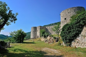 A historic stone castle with a central tower and a surrounding wall, set in a lush green landscape. - Pool Villa Cupido in Crikvenica - Drivenik (Vinodol)