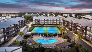 A hotel with multiple tennis courts, a swimming pool, and a covered seating area. - Sea Blue Suite at Tilghman w Pool and Hot Tub (North Myrtle Beach)