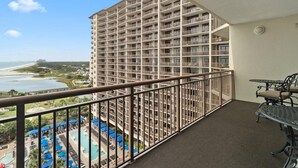 A high-rise hotel with multiple balconies, a pool area, and a view of the beach. - Waves and Relaxation: 2Bdrm Condo with Jetted Tub (North Myrtle Beach)