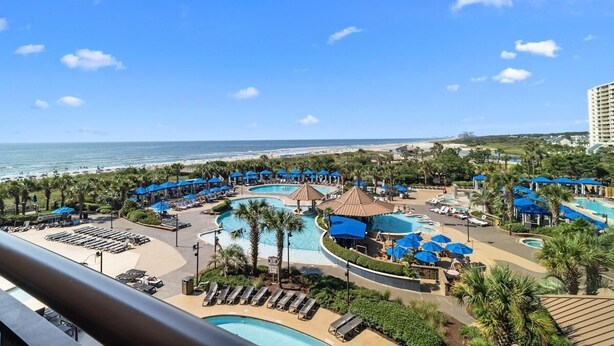Ein Resort mit mehreren Schwimmbecken, Zugang zum Strand und Blick auf den Ozean.