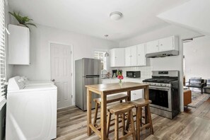 Enjoy cooking in this well-equipped kitchen with a central island, oven, and microwave.