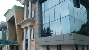 A modern building with large windows and a brick facade. - Lushville Hotel and Suites  (Benin City)