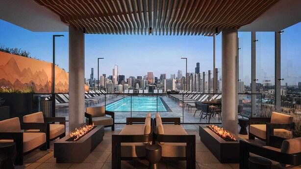 Terraza en la azotea con piscina, zona de estar y vistas a la ciudad.