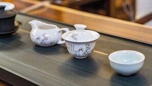 A tray with a teapot, a pitcher, and a small bowl.
