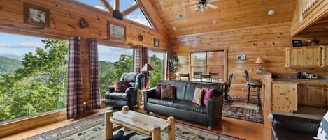 A spacious cabin with a large living area, a dining table, and a kitchen.