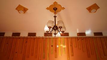 A ceiling with a chandelier and three wall-mounted lights.