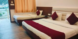 A hotel room with two beds, a wooden floor, a view of the outside, and a window with curtains. - Pride Inn Luxury Resort (Yamkeshwar)