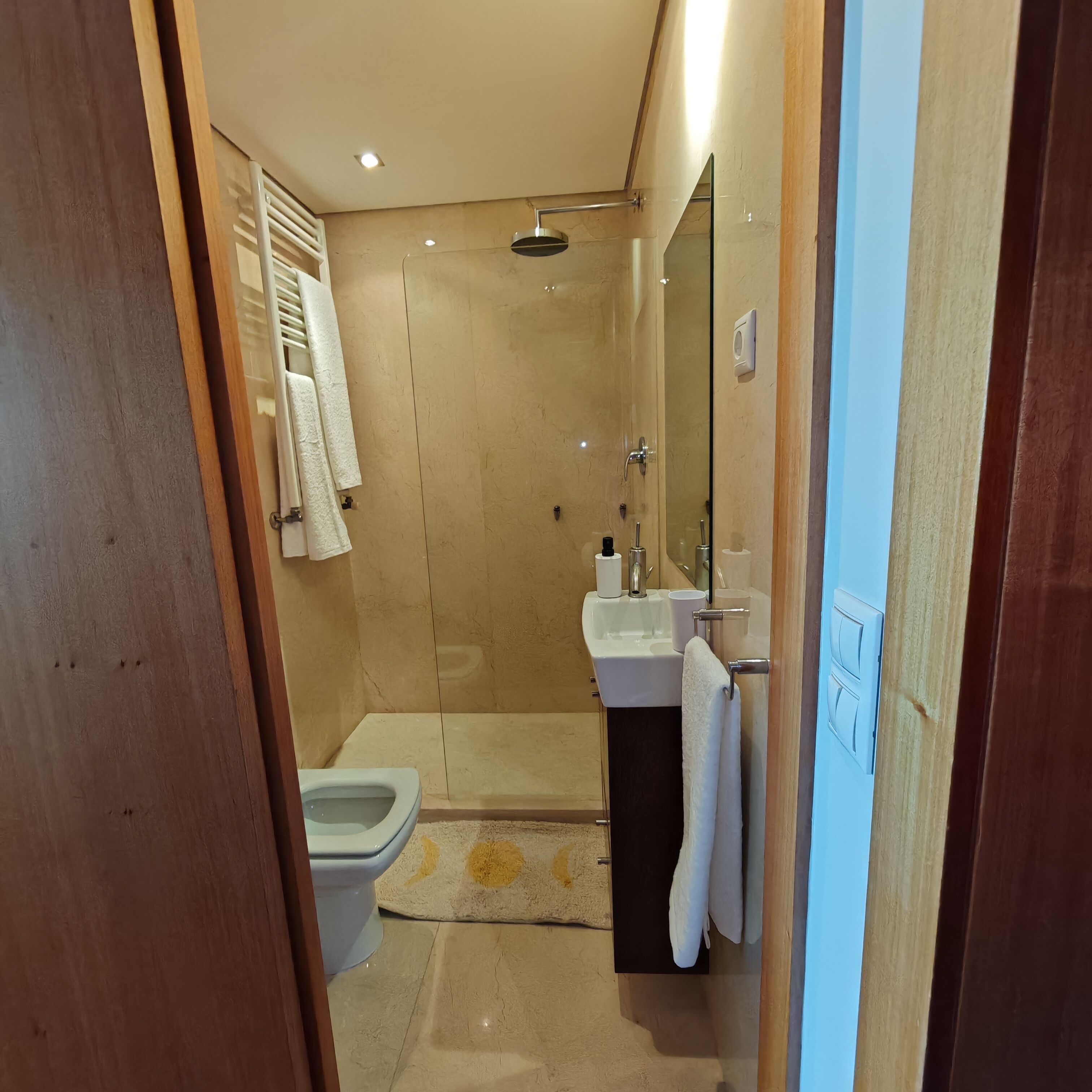 A bathroom with a shower, toilet, and sink.