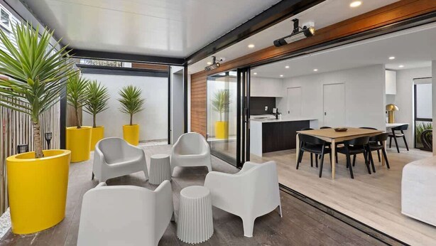 Un interior moderno con comedor, cocina y zona de estar.