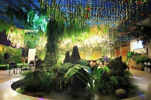 An indoor space with hanging lights, plants, and seating areas. - Yiyang Hotel (Yiling Wanda Plaza, Yichang Three Gorges Enterprise Base) (Yichang)