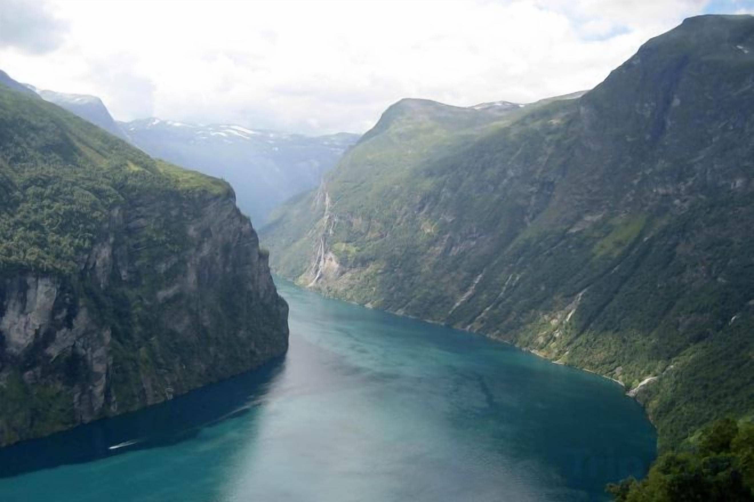 A canyon with a river, surrounded by steep cliffs.