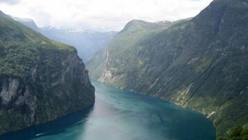 A canyon with a river, surrounded by steep cliffs.