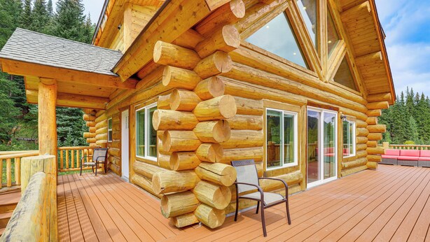 A log cabin with a deck, large windows, and a chair. - Log Cabin w/ Wraparound Deck in Breckenridge! (Breckenridge)