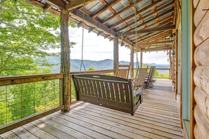 A wooden deck with a swing, overlooking a mountainous landscape. - Bryson City Cabin: Hot Tub + Mtn View! (Bryson City)